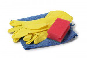 Protective rubber gloves and cleaning products on white backgroud